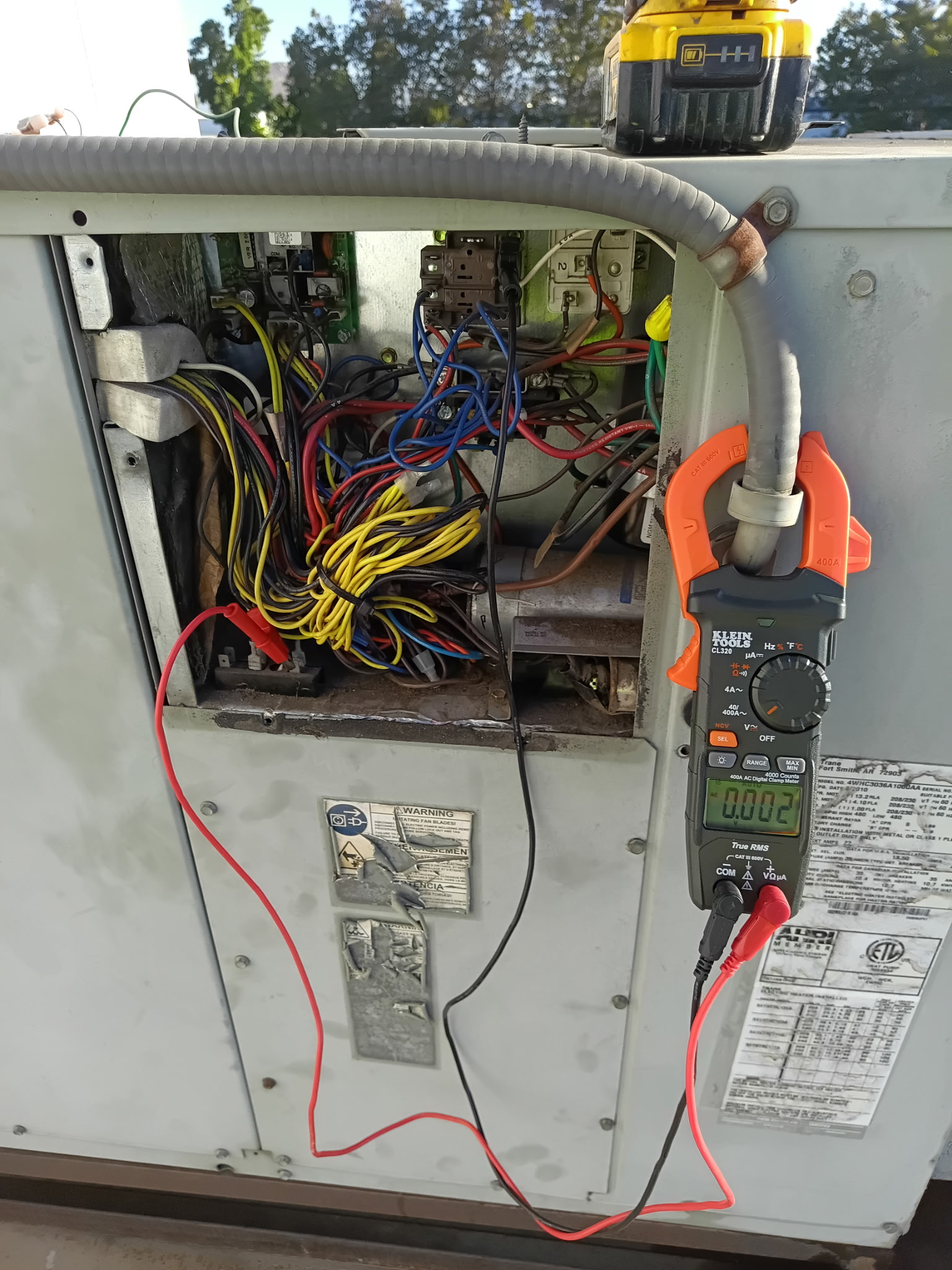 HVAC control wiring and electrical testing with a clamp meter.